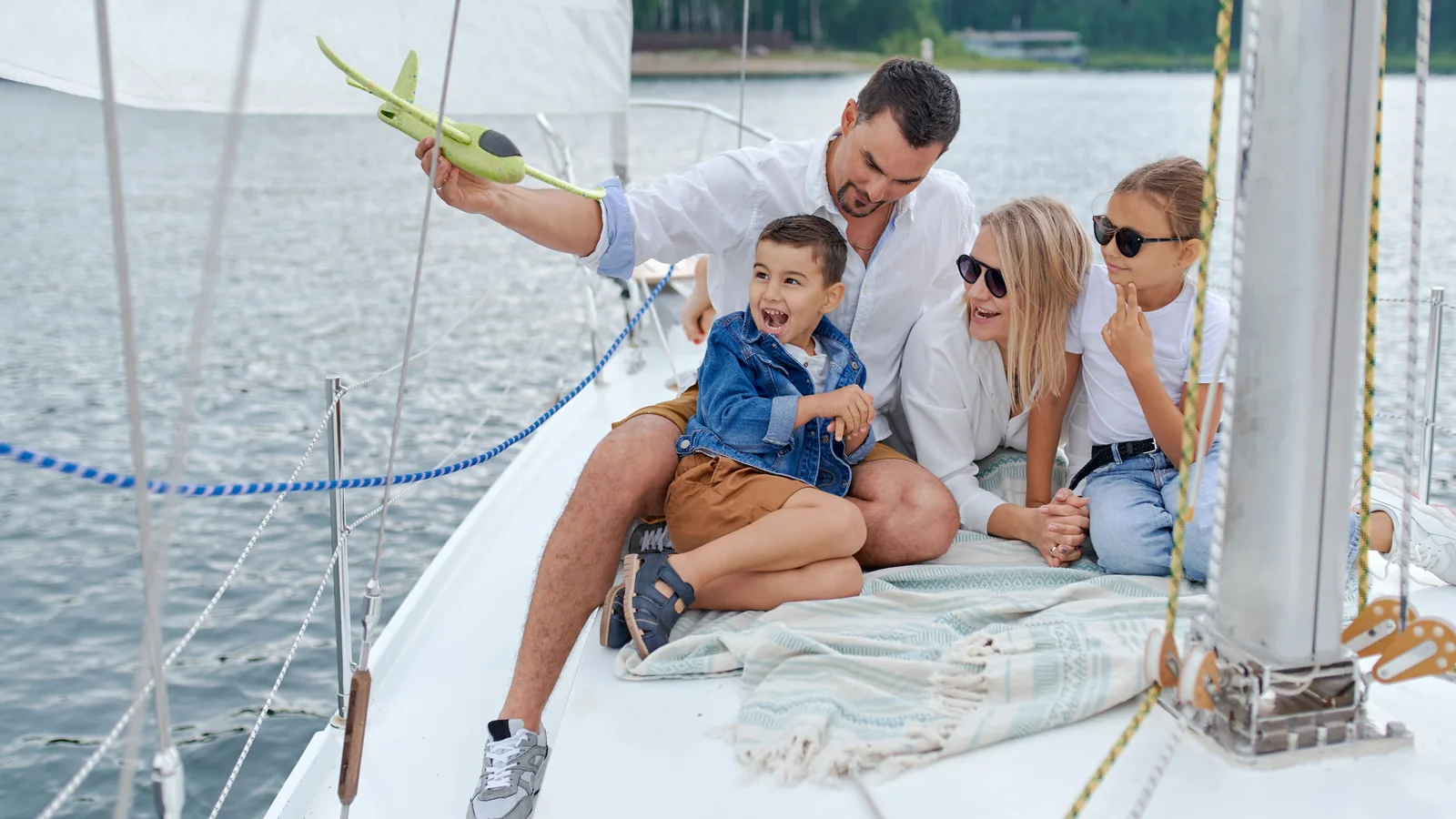 A family of four enjoying a golden hour sail together