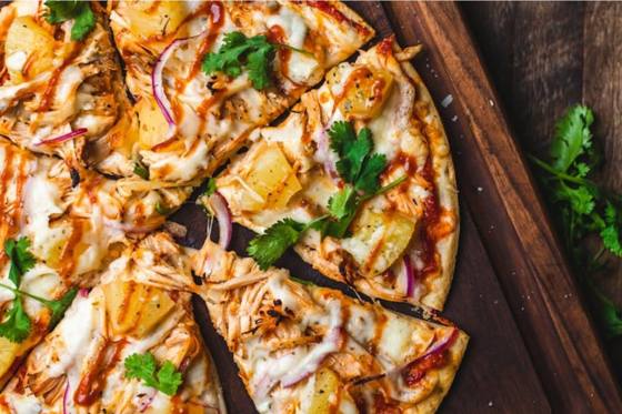 A shared pizza on a wooden board